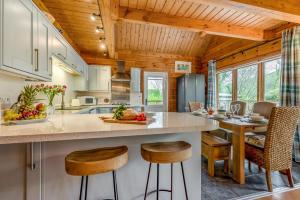 a kitchen with a large island with bar stools at 3 Bed in Wadebridge oc-p34722 in Little Petherick
