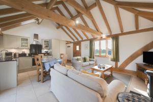 a living room with couches and a kitchen in a house at 2 Bed in Tenterden oc-tn607 in Stone