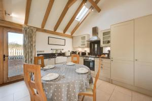 a dining room with a table and chairs and a kitchen at 2 Bed in Tenterden oc-tn607 in Stone +17 photos