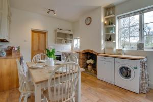 a kitchen with a table and a washing machine at 2 Bed in Biddenden oc-cb616 in Biddenden