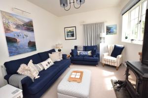 a living room with a blue couch and chairs at 2 Bed in Biddenden oc-cb616 in Biddenden