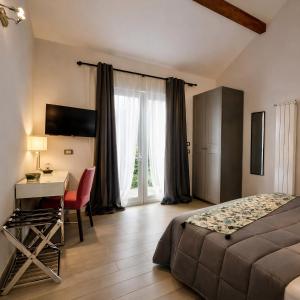 a bedroom with a bed and a desk and a table at Hotel Del Borgo in Sestri Levante