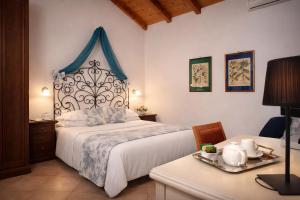 a bedroom with a large bed with a blue canopy at Hotel Del Borgo in Sestri Levante