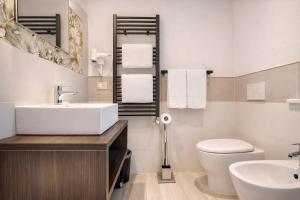 a white bathroom with a sink and a toilet at Hotel Del Borgo in Sestri Levante +22 photos