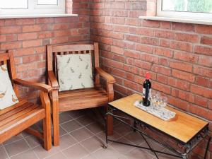 two chairs and a table with a bottle of wine at Tom Putt in Ledbury
