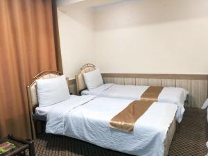a hotel room with two beds and a window at Star Shirpoor Guest House in Kabul