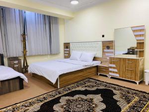 a bedroom with two beds and a mirror at Star Shirpoor Guest House in Kabul