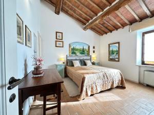 a bedroom with a bed and a desk in a room at La Pietra Dorata in Rapolano Terme +23 photos