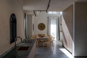 a kitchen and dining room with a table and chairs at Villa Riad- וילה ריאד מתחם נופש יוקרתי in Migdal