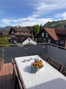 a table with a bowl of food on a balcony at Ruhige Stadtwohnung, 107 m2 in Dornbirn