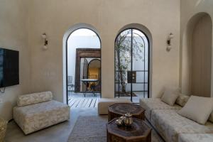 a living room with a couch and a table at Villa Riad- וילה ריאד מתחם נופש יוקרתי in Migdal