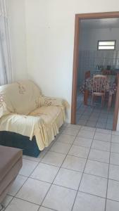 a bedroom with a bed and a tiled floor at José Nilton in Imbituba