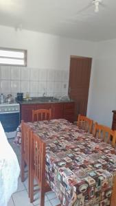 a kitchen with a table with a patterned table cloth at José Nilton in Imbituba