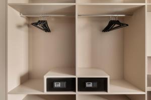 a walk in closet with two black umbrellas at Living Hotel Milano in Cornaredo