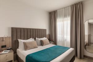 a bedroom with a large bed and a large window at Living Hotel Milano in Cornaredo +101 photos