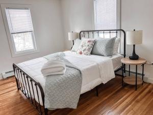 a bedroom with a bed with white sheets and pillows at Kenoza House with Private Lake and Kayaks in Callicoon
