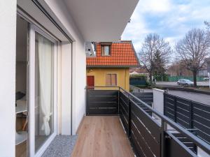 a balcony with a view of a yellow house at GINO SUITES - Monolocali Luxury - Appartamenti vicini a Rho Fiera e Milano in Bollate