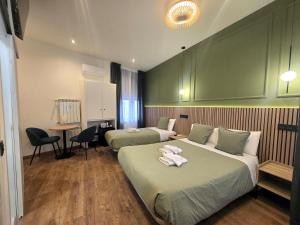 a hotel room with two beds with towels on them at Hostal Main Street Madrid in Madrid
