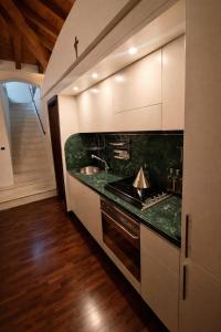 a kitchen with a sink and a stove top oven at Atelier Monte Bago in Felegara +14 photos