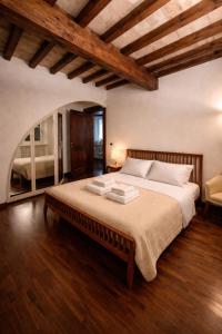 a bedroom with a large bed in a room at Atelier Monte Bago in Felegara