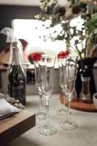 three wine glasses with a strawberry in them on a table at Rose Meadow Lodge in Liscannor