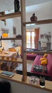 a living room with a loft bed with a purple couch at Facing the Sestriere Ski Slopes in Borgata Sestriere +76 photos
