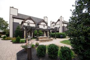 a building with a picnic table and benches in a courtyard at Eden Resort and Suites, BW Premier Collection in Lancaster