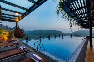 a swimming pool with a view of the mountains at Serene Kandy in Kandy
