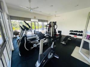 a gym with treadmills and exercise bikes in it at Apartment For Rent in Ambulgama