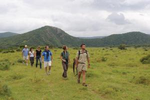 a group of people walking in a field at Kariega Game Reserve Main Lodge in Kenton on Sea