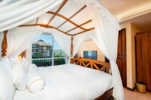 a bedroom with a white bed with a canopy at Serene Kandy in Kandy +102 photos