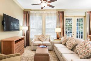 a living room with a couch and a flat screen tv at Royal Dunes in Hilton Head Island