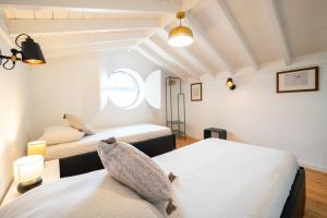 a room with two beds and a window at Liiiving in Açores - Casa de Foros in Foros