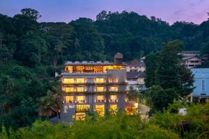 a building in the middle of a town with trees at Serene Kandy in Kandy