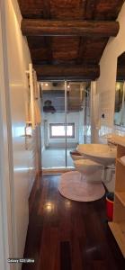 a bathroom with a toilet and a sink at Skyline Virgilio SUITE sottotetto vista MARE parking in San Marino +11 photos