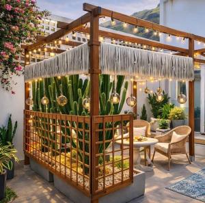 a patio with a pergola with lights and plants at WELCOME in Garachico
