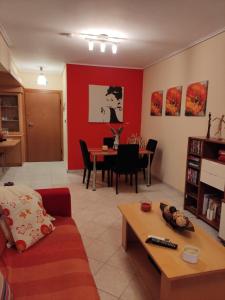 a living room with a couch and a table at Dancer's Home in Korinthos +13 photos