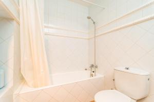 a white bathroom with a toilet and a bath tub at Ca Na Carme (Alaronera) in Alaró +23 photos
