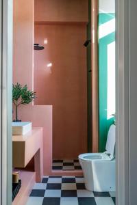 a bathroom with a toilet and a sink at The Urban Parrot Maisonette in Ermoupoli +75 photos