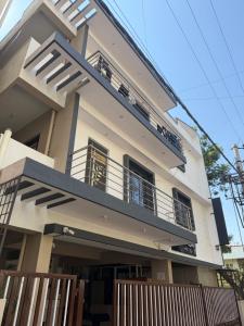 a large white house with a balcony at Haven Homes in Yelahanka