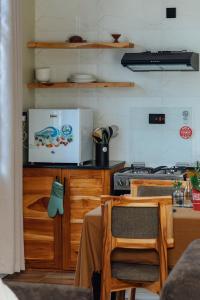 a kitchen with a stove and a table with chairs at Starico Residence in Nkoanrua +11 photos