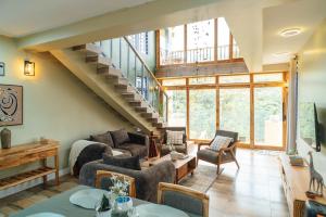 a living room filled with furniture and a staircase at Starico Residence in Nkoanrua