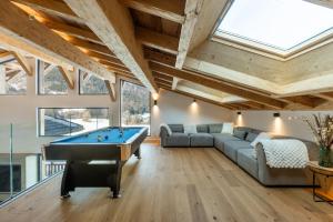 a room with a pool table in a house at Chalet Imperial by Altitudia in Morzine