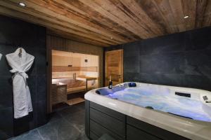 a large bathroom with a tub and a shower at Chalet Imperial by Altitudia in Morzine