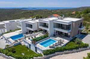 an aerial view of a house with a swimming pool at Villa Olive Tree in Vinišće
