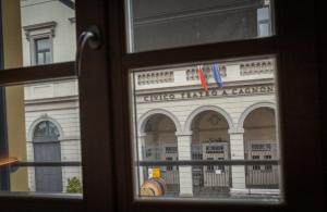 a view of a building through a window at Dimora Del Teatro in Vigevano