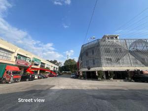 a street view of a building with cars parked at Above A Shoplot No Noise Worries 12Pax & FreeWiFi in Ipoh