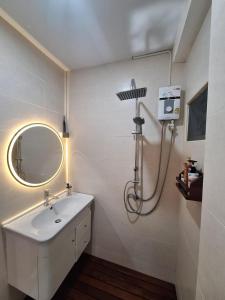 a bathroom with a sink and a mirror at The Lighthouse Seaview Hotel in Rawai Beach +29 photos