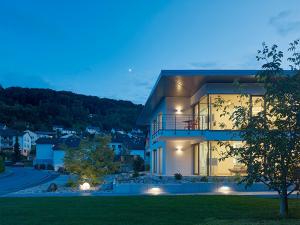 a large house with lights on the side of it at Lumina Apartments in Ingelfingen