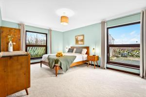 a bedroom with a bed and a large window at Mullaghmore Holiday Home in Cliffony
